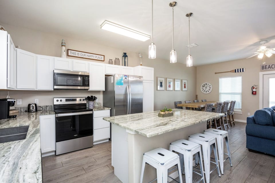 Gather around your spacious kitchen island with granite counters and modern appliances, perfect for memorable meals together.
