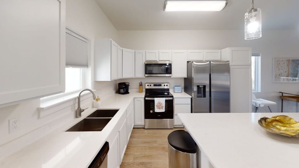 Your bright, fully-equipped kitchen invites culinary adventures with stainless steel appliances, generous counter space, and everything needed for memorable meals.
