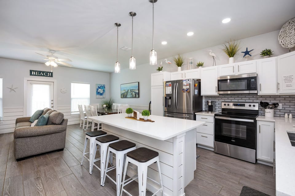 Your spacious beach-themed kitchen invites culinary adventures with modern appliances, granite counters, and coastal charm throughout.