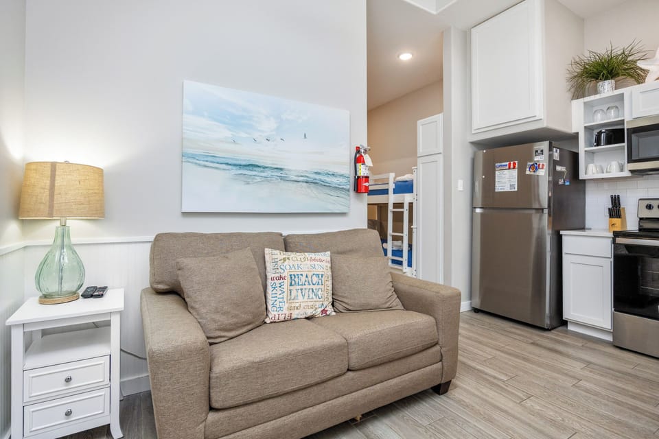 Unwind in your bright, beach-themed living space with modern kitchen and cozy bunk beds perfect for families.