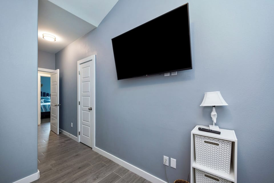 Unwind in your spacious living area with wall-mounted TV and stylish storage solutions for all your belongings.