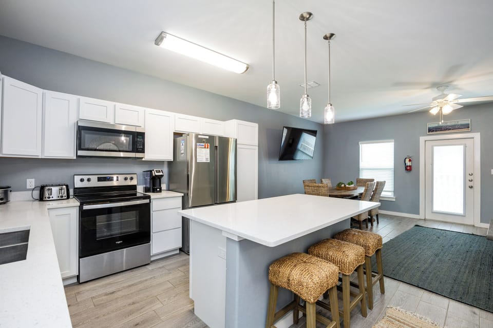 Your modern kitchen awaits with sleek appliances, spacious island seating, and stylish pendant lighting for memorable meals together.