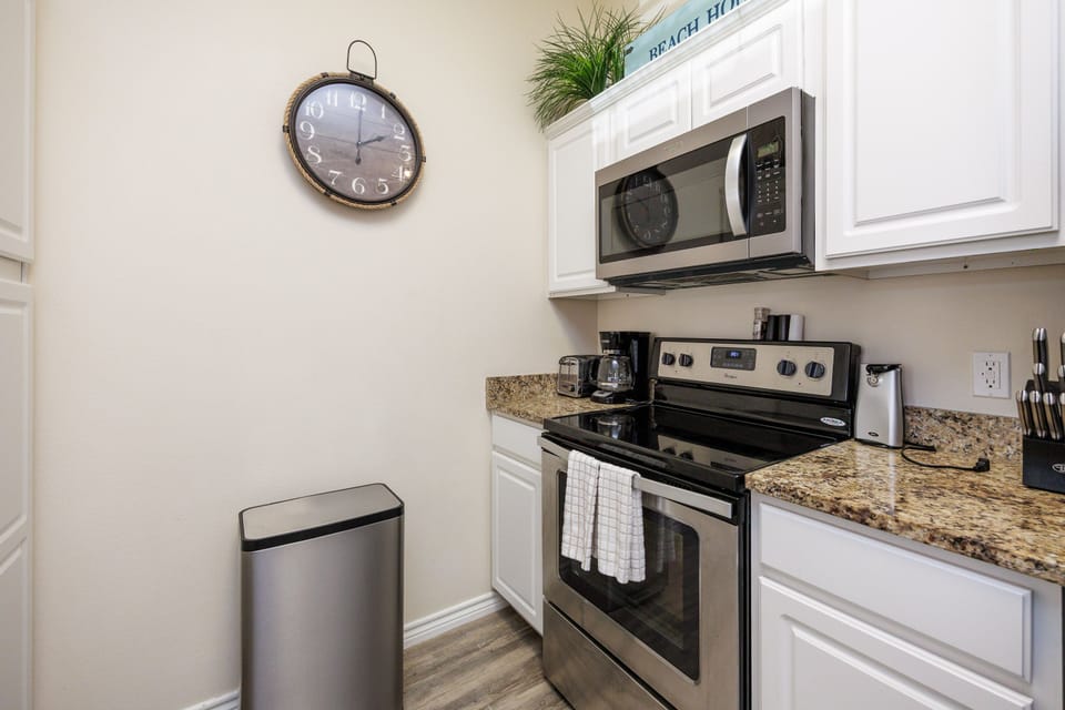 Your fully equipped kitchen awaits with granite countertops, stainless steel appliances, and everything you need to create delicious meals during your beach getaway.