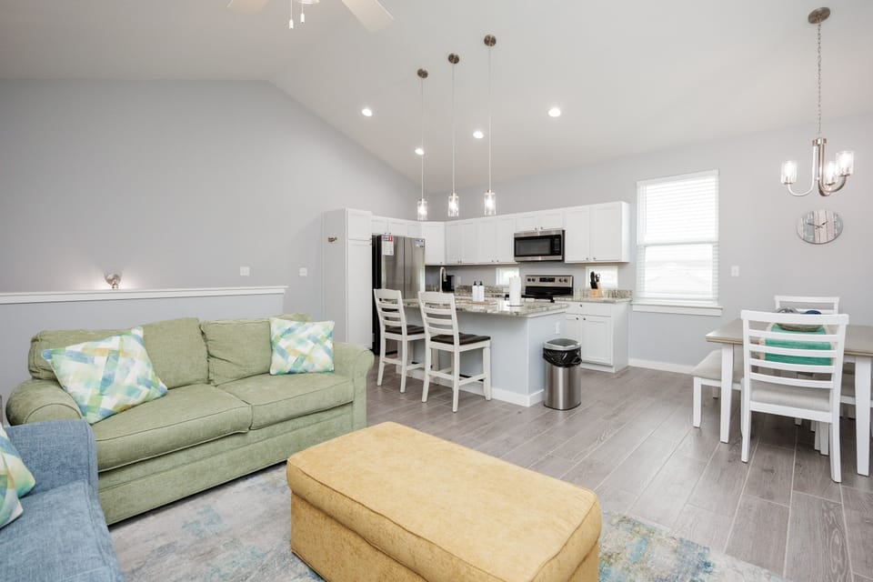 Relax in your bright open-plan space where cozy living flows into a fully equipped kitchen—perfect for memorable meals and quiet evenings.