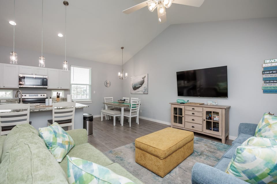 Unwind in your bright open living space with comfortable seating, modern kitchen, and coastal-inspired décor.