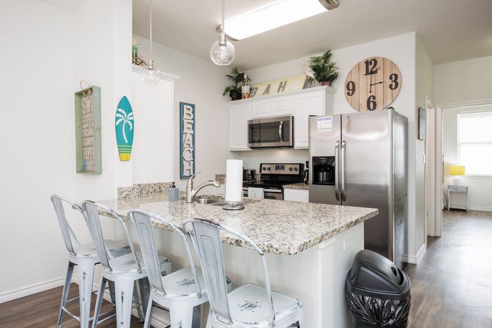 Your coastal-themed kitchen offers granite counters, stainless appliances, and beach decor for memorable meal prep together.