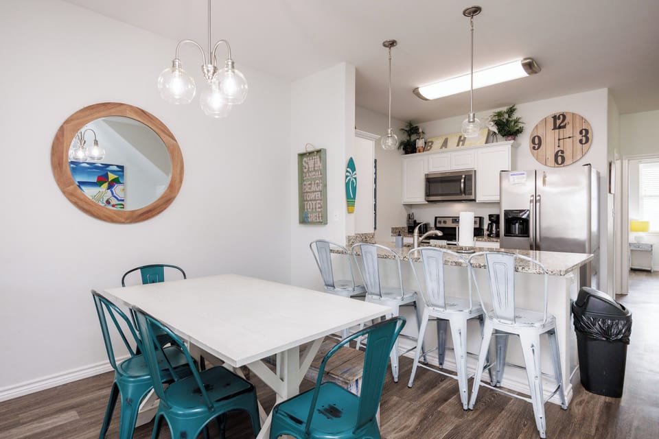Your bright, open kitchen and dining space features modern appliances and cheerful coastal touches, perfect for sharing meals together.