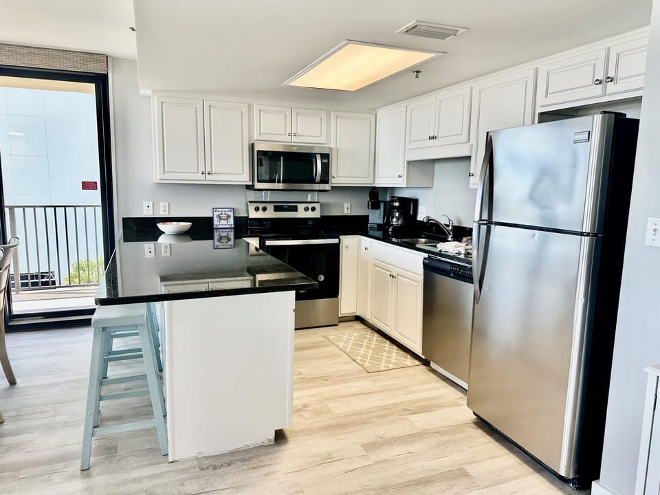 Sleek stainless steel appliances and granite countertops.