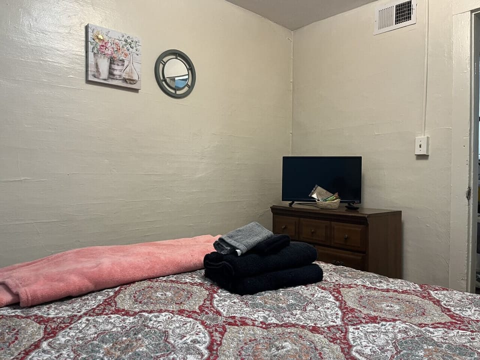 Experience comfort in our two intimate bedrooms, each featuring a queen-sized bed. Enjoy privacy and relaxation for a restful night’s sleep, complete with a stylish dresser and smart TV to unwind after your day.