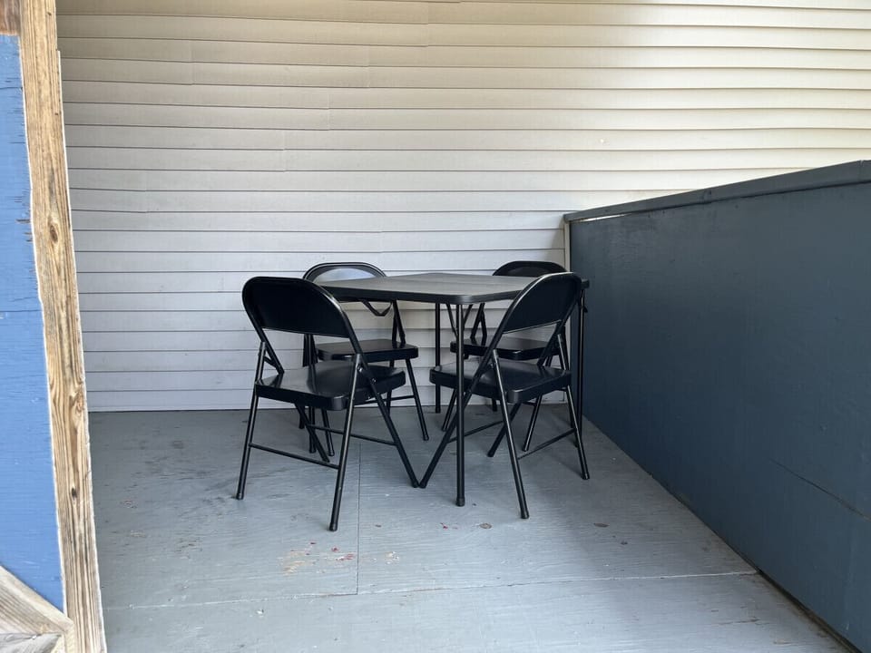 Enjoy this outdoor living area.  Comfortably furnished to enjoy your morning coffee or wind down your evening.  1 flight down to the kitchen and outdoor eating area.