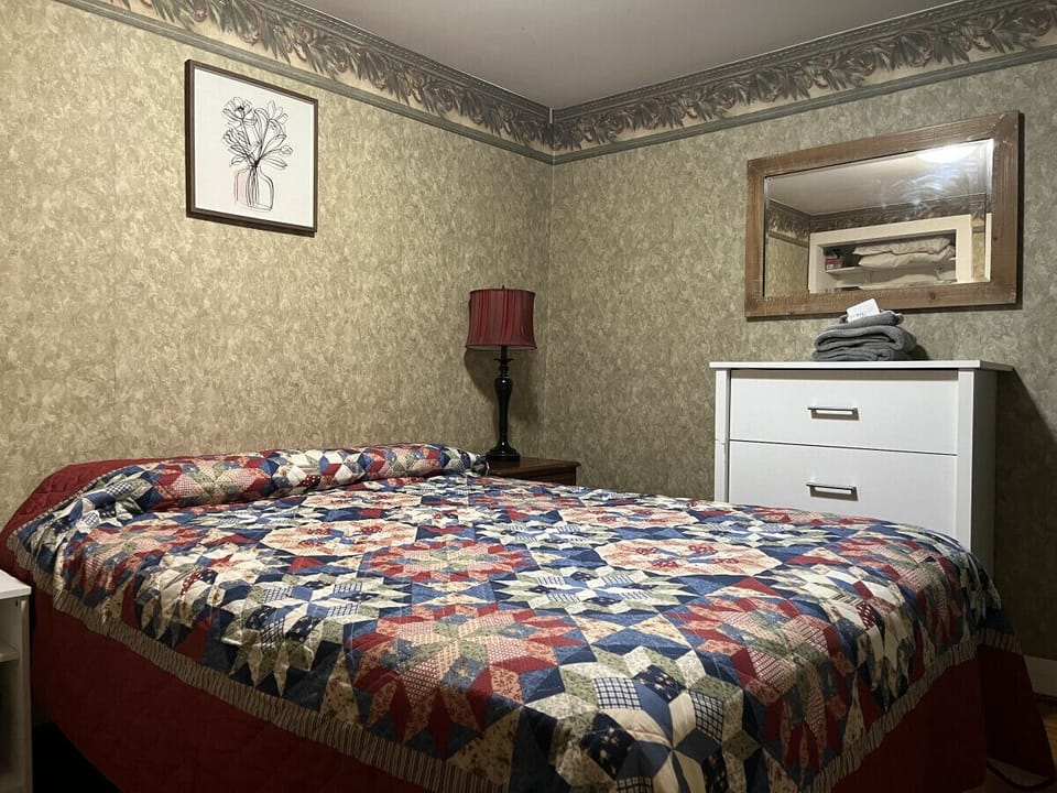 Indulge in a restful escape within this cozily designed bedroom, boasting a pleasant queen bed, a dedicated workspace with a desk, a dresser, and a generous closet. Experience the perfect blend of comfort and sophistication