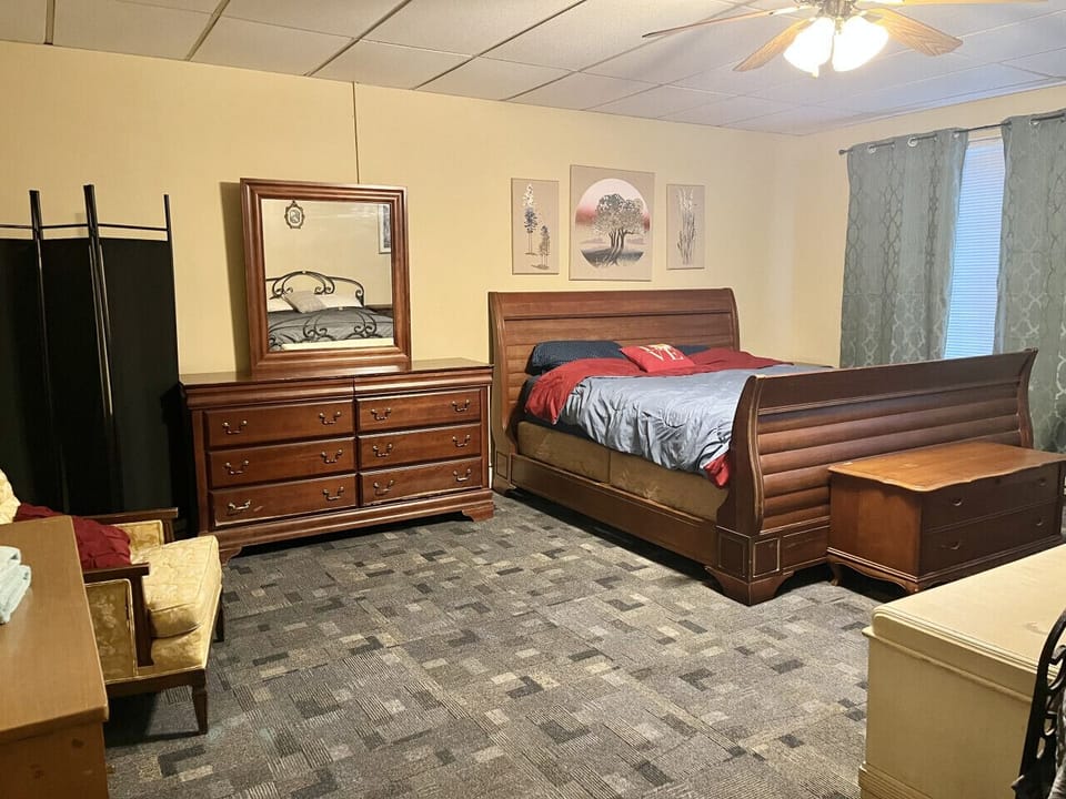 Spacious bedroom boasting a King and queen bed along with a comfortable sitting area.