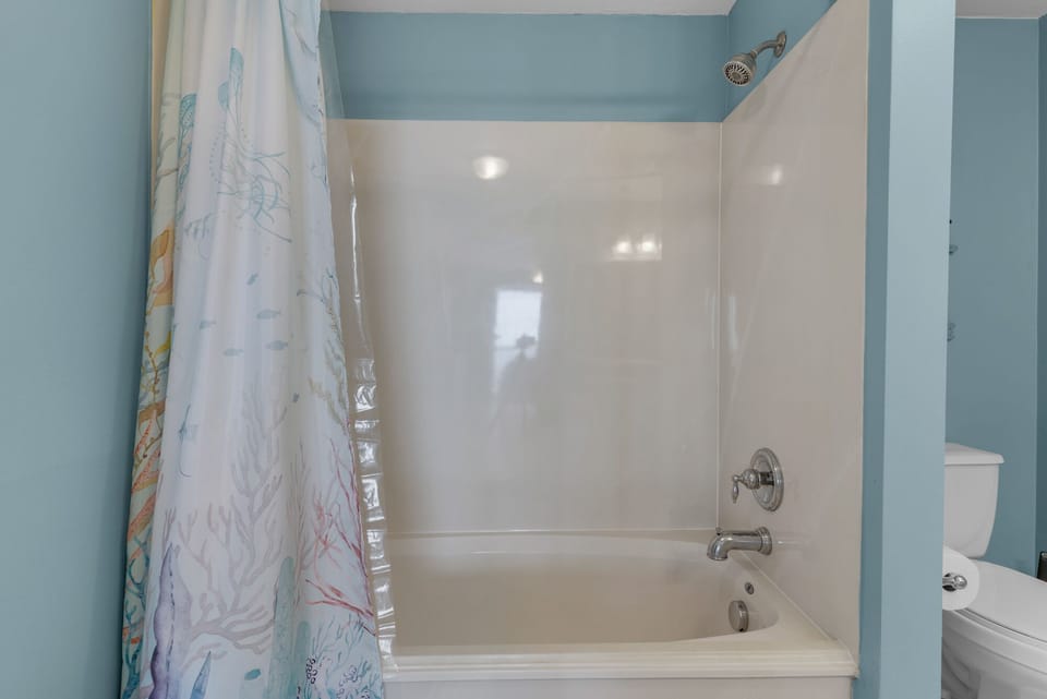 The primary bath has a shower and tub combo, with dual sinks.