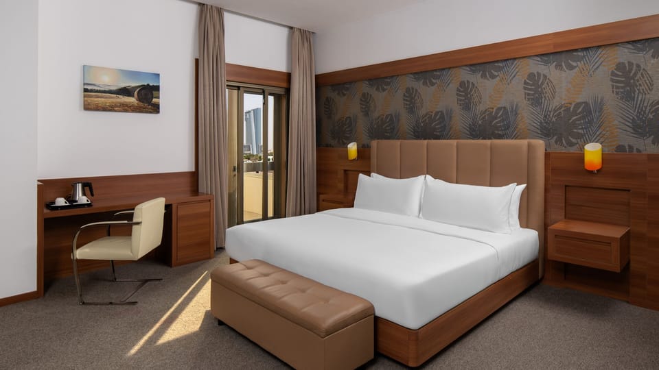 Premium bedding, desk, laptop workspace, blackout drapes