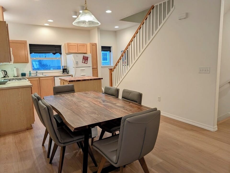 Dining and kitchen area with view of stairs going up to the third floor