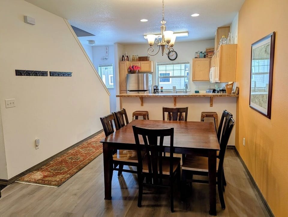 Large dining table with seating for 6. There are also 3 stools at the breakfast bar