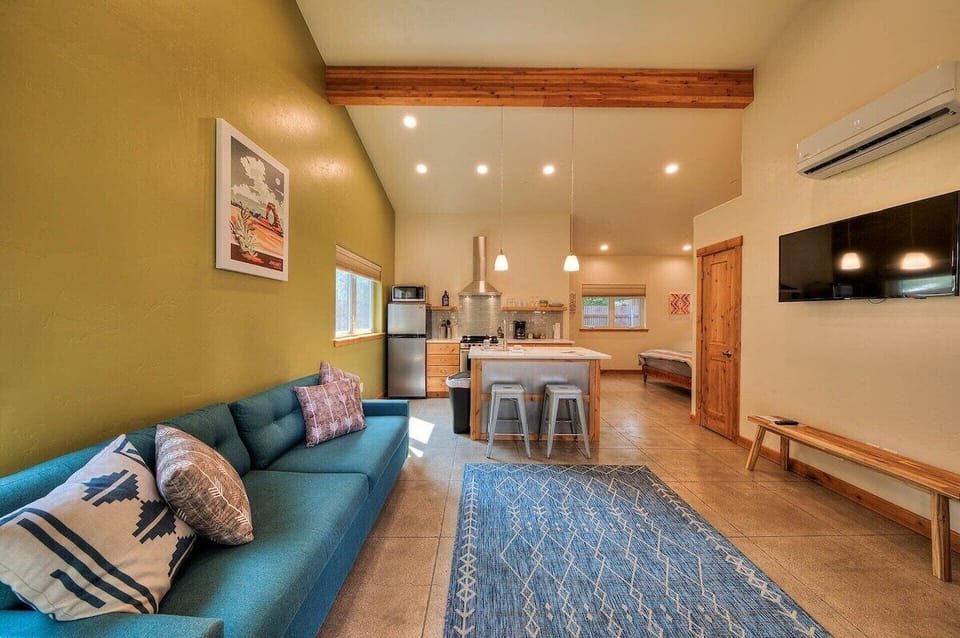 Family room opens to kitchen with TV, sofa, and vaulted ceiling