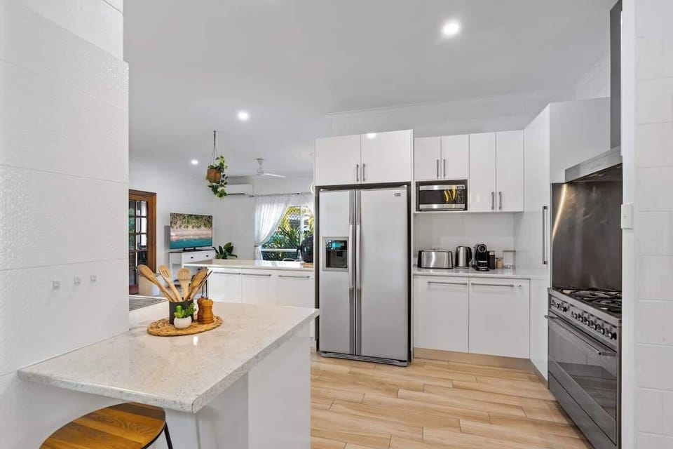 With generous bench space and modern appliances, the bright open kitchen makes shared holiday cooking feel effortless and social.