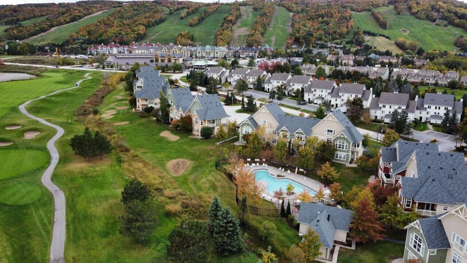 View of the Condo Complex from above the Golf Course with The Blue Mountains in the background
