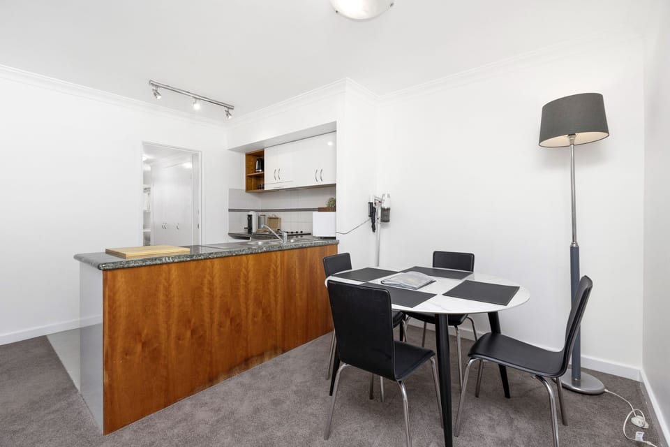 Imagine enjoying a meal at this dining table, overlooking the well-equipped kitchen.