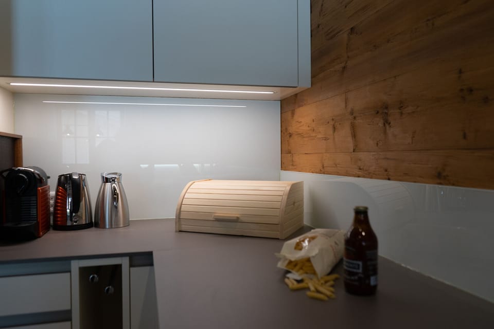 Kitchenette with coffee machine, kettle and bread bin