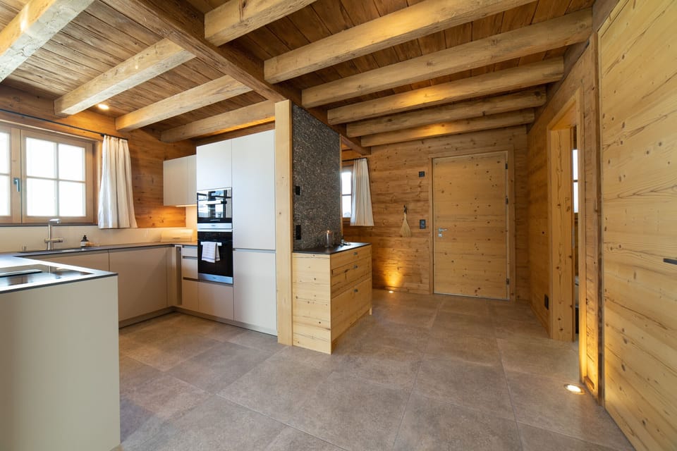Modern kitchen and entrance area with rustic wooden decking
