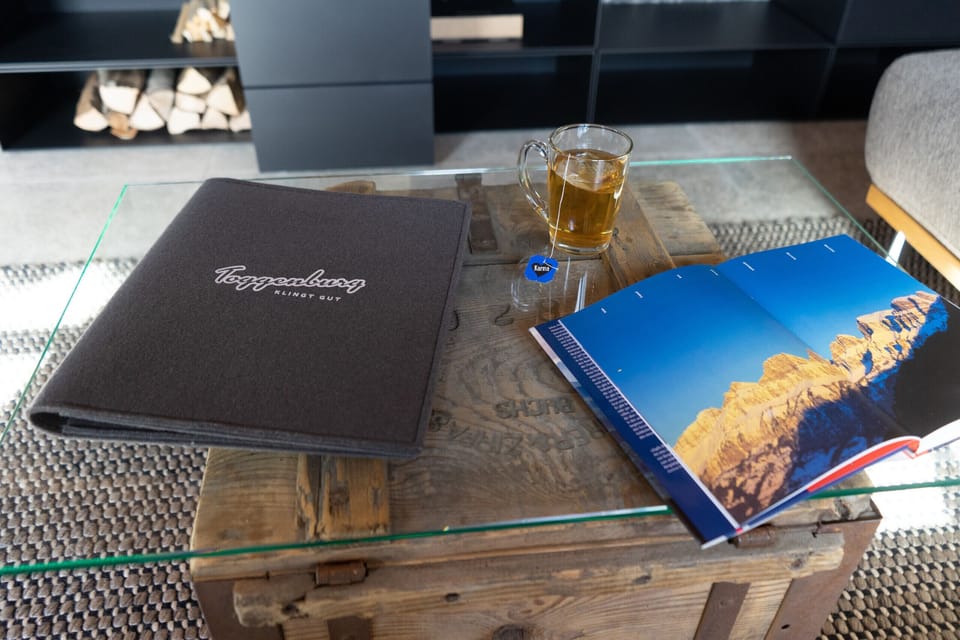 Guest book and Toggenburg magazine on a rustic coffee table