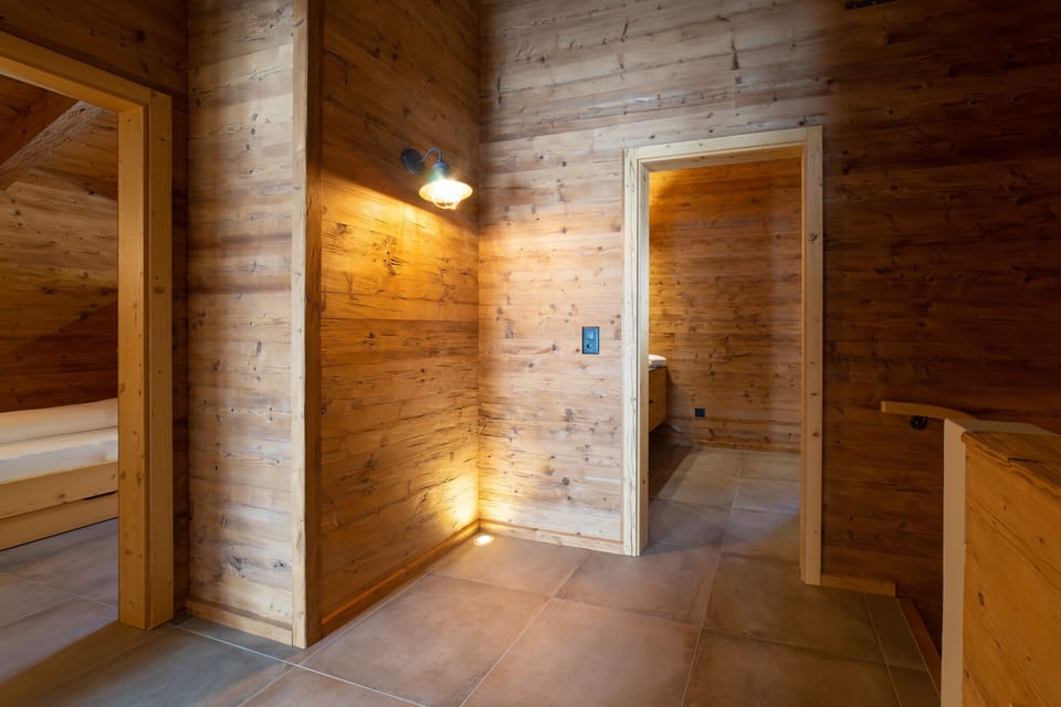 Upper-floor hallway with wooden walls and warm lighting