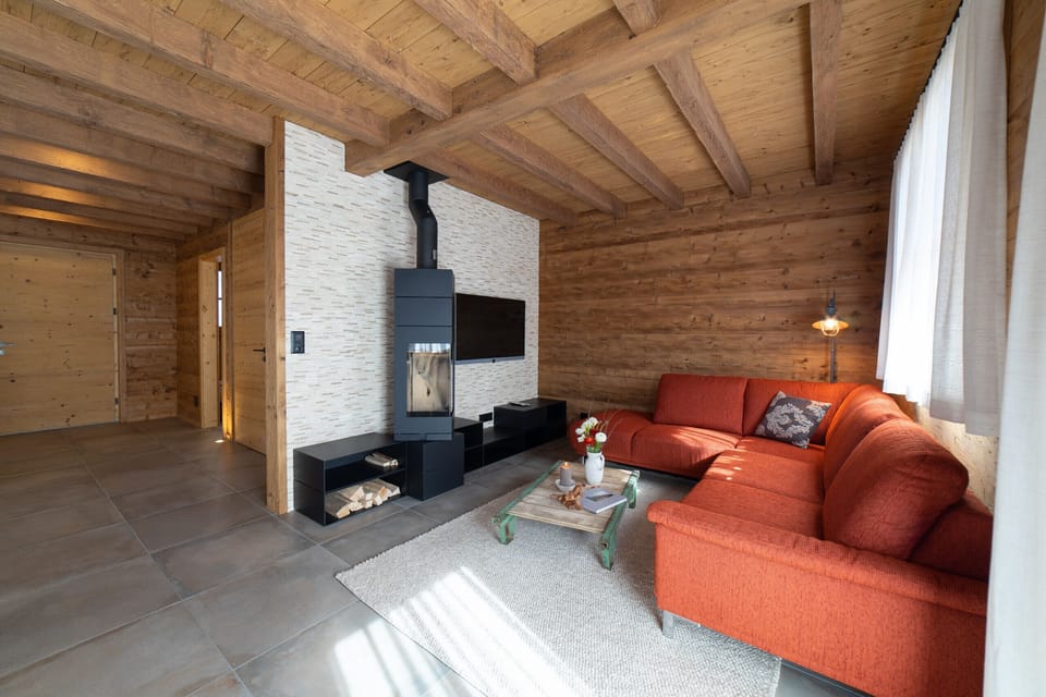 Living area with red corner sofa and fireplace