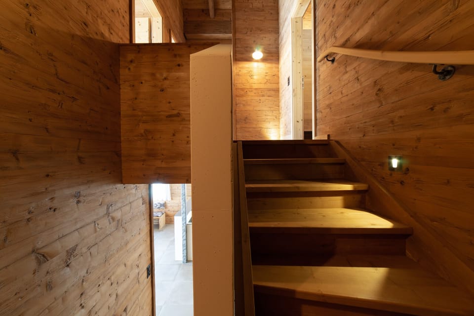 Wooden chalet staircase with warm lighting