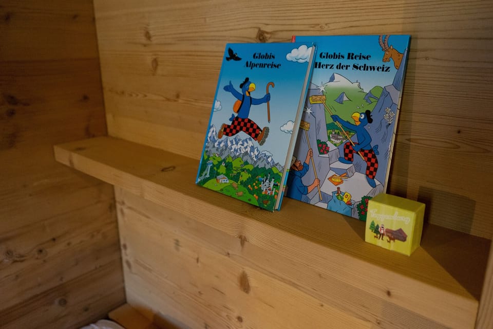Children’s books and a game on a wooden shelf
