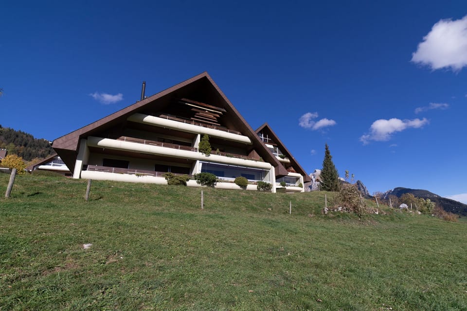 House with balconies on a grassy hillside
