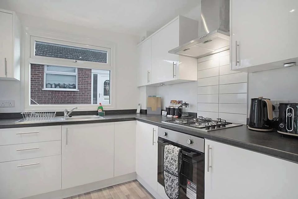 Kitchen equipped with all essentials, including a washer & dryer, oven, fridge and full cookware set.