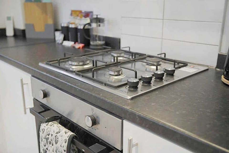 Kitchen equipped with all essentials, including a washer & dryer, oven, fridge and full cookware set.