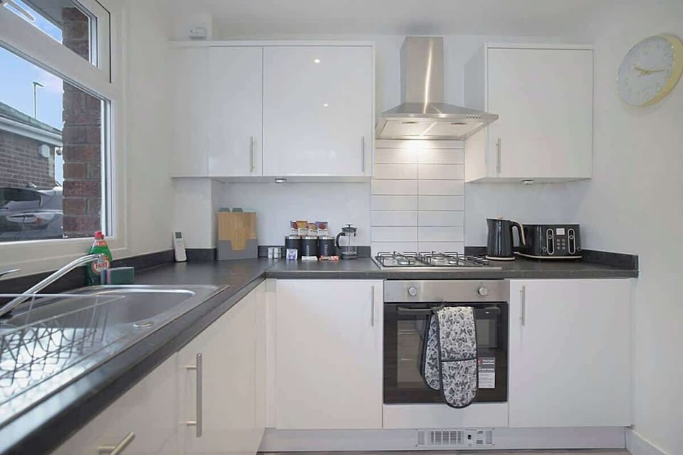 Kitchen equipped with all essentials, including a washer & dryer, oven, fridge and full cookware set.