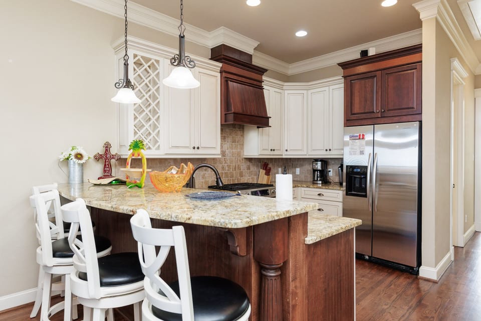 Your fully equipped kitchen features granite countertops, stainless appliances, and a breakfast island where you can cook and dine together.