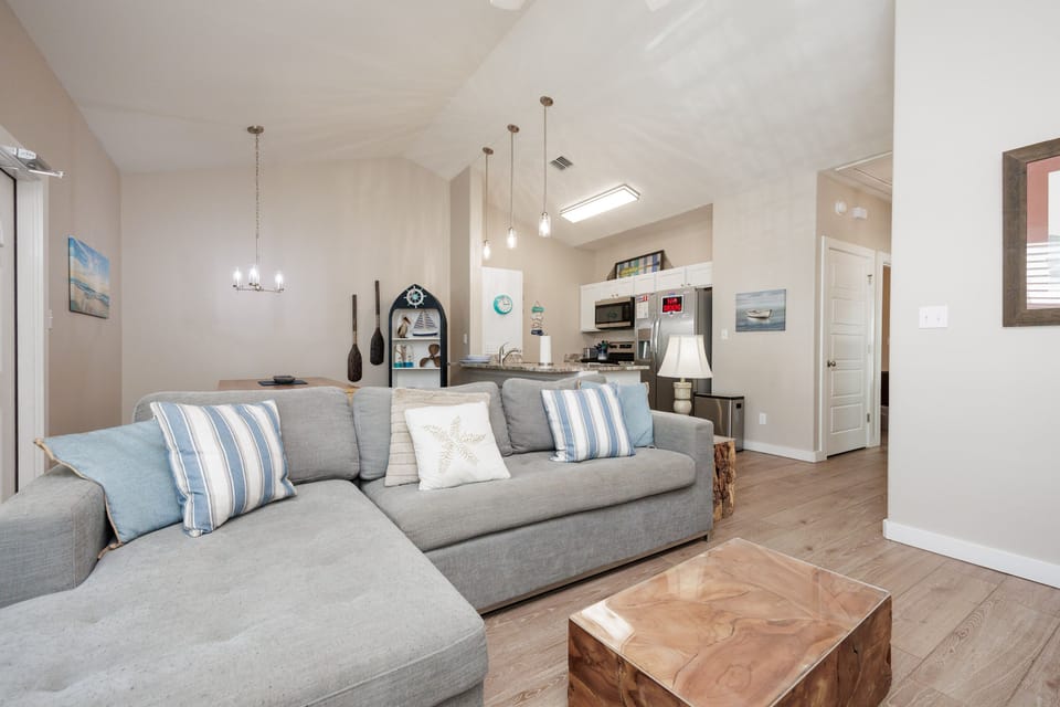 Relax in this bright, coastal-themed living space where soft blues and nautical touches create your perfect beachside retreat.