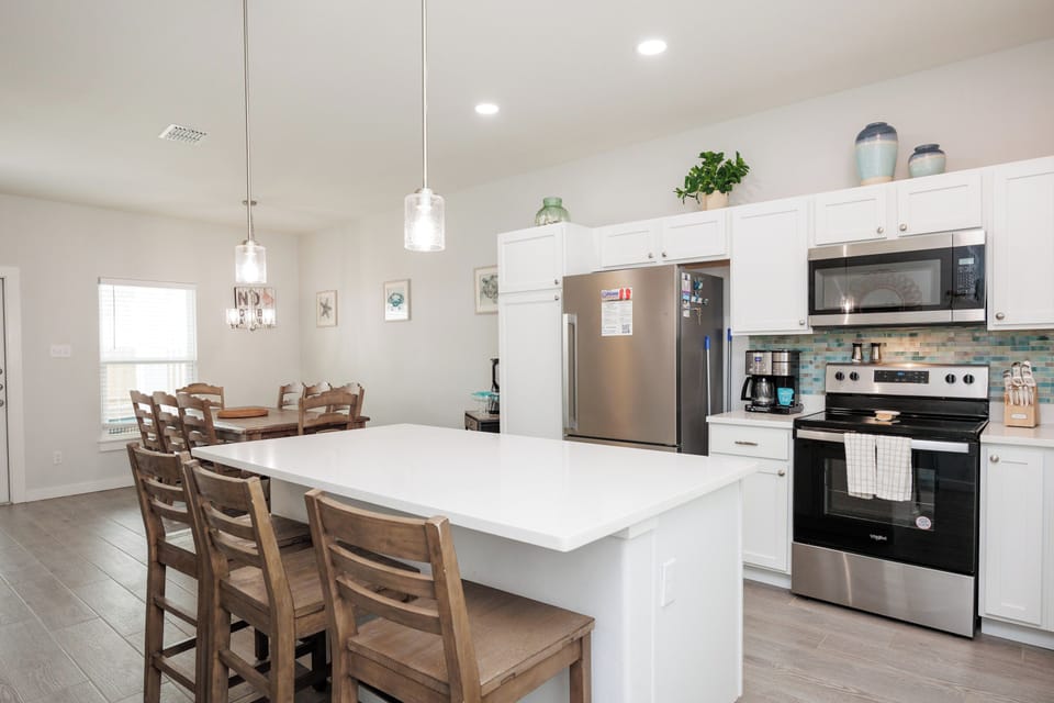 Your spacious kitchen features stainless steel appliances, a large island for meal prep, and bar seating perfect for morning coffee.