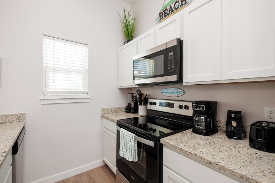 Your fully equipped kitchen invites you to create culinary memories with granite counters, modern appliances, and coastal charm.