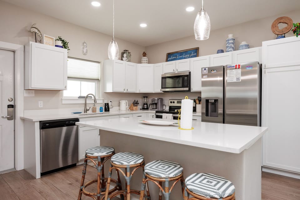 Your fully-equipped kitchen features stainless appliances, granite counters, and breakfast bar seating for four—perfect for group meals and morning coffee.