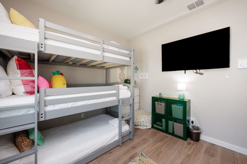 Cozy bunk room where your little ones can drift off to sleep, complete with playful décor and entertainment for bedtime stories.