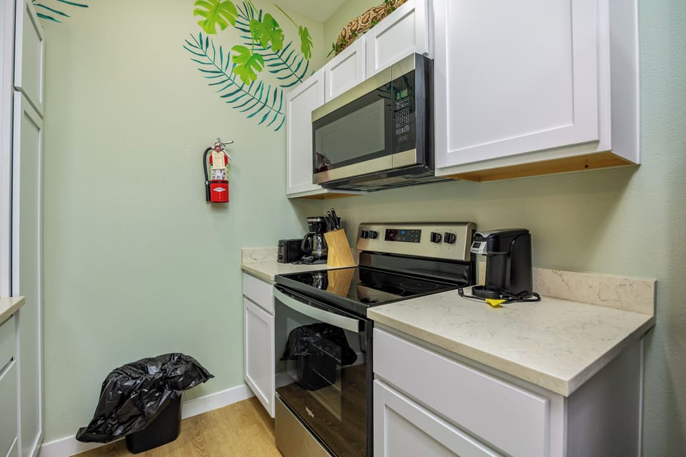 Your fully equipped kitchen awaits with stove, microwave, and coffee maker—perfect for preparing meals and morning brews during your stay.