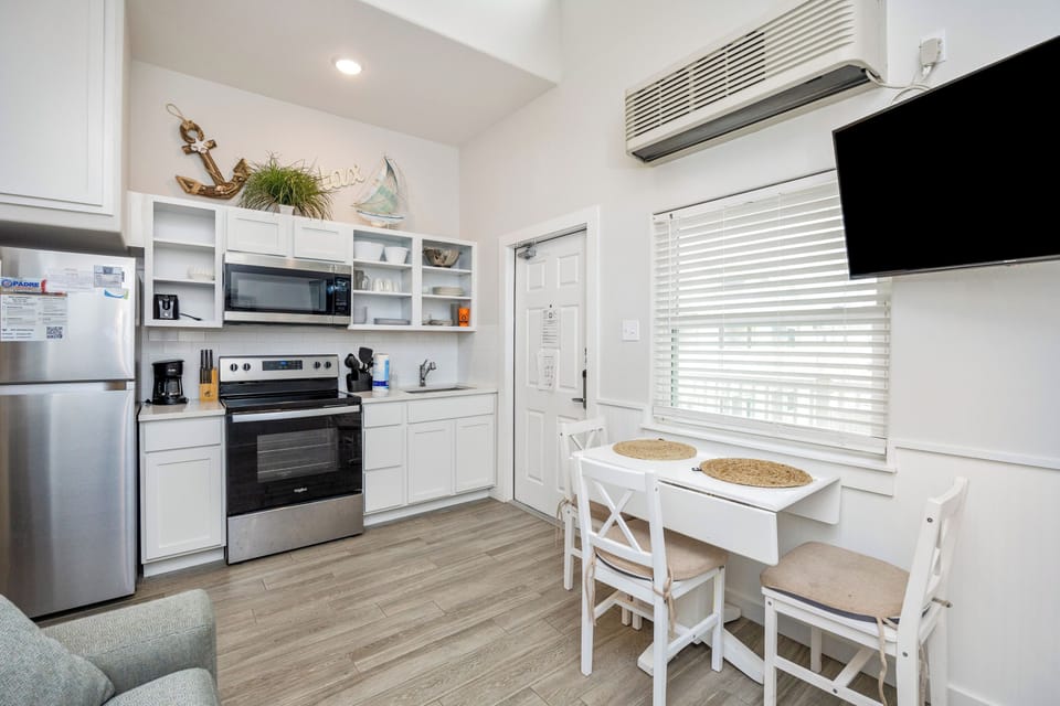 Your bright kitchen features stainless steel appliances, charming nautical touches, and a cozy dining nook where you can enjoy meals together.