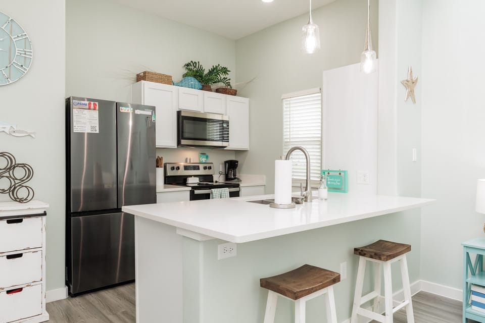 Your bright, fully-equipped kitchen features stainless steel appliances and a breakfast bar where you can enjoy morning coffee.