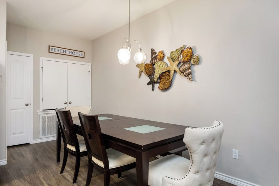 Gather around your stylish dining table beneath coastal-inspired art, where memories are made over every meal.
