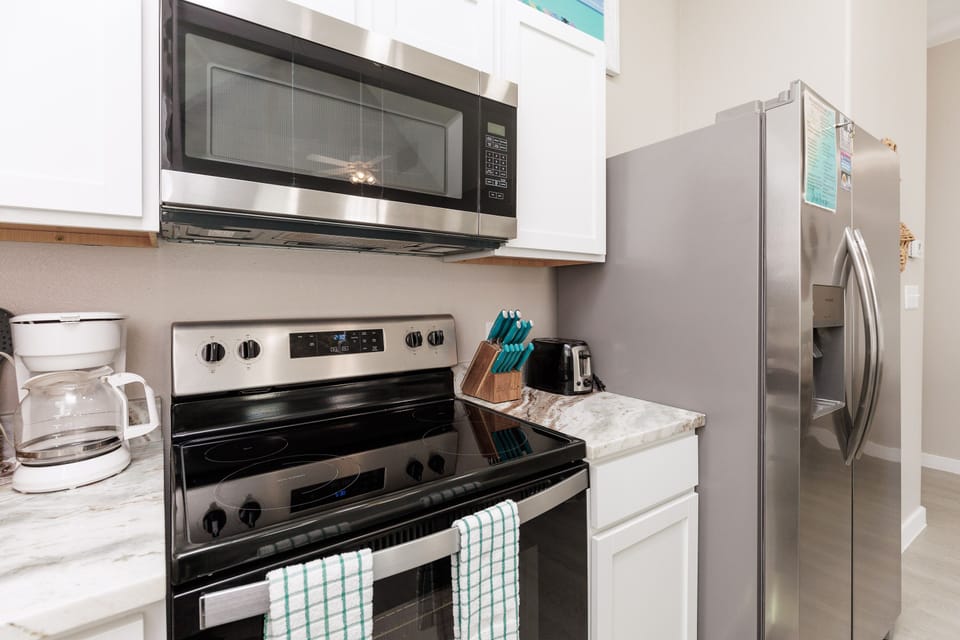 Your fully equipped kitchen features stainless steel appliances, marble countertops, and everything you need to create memorable meals during your stay.
