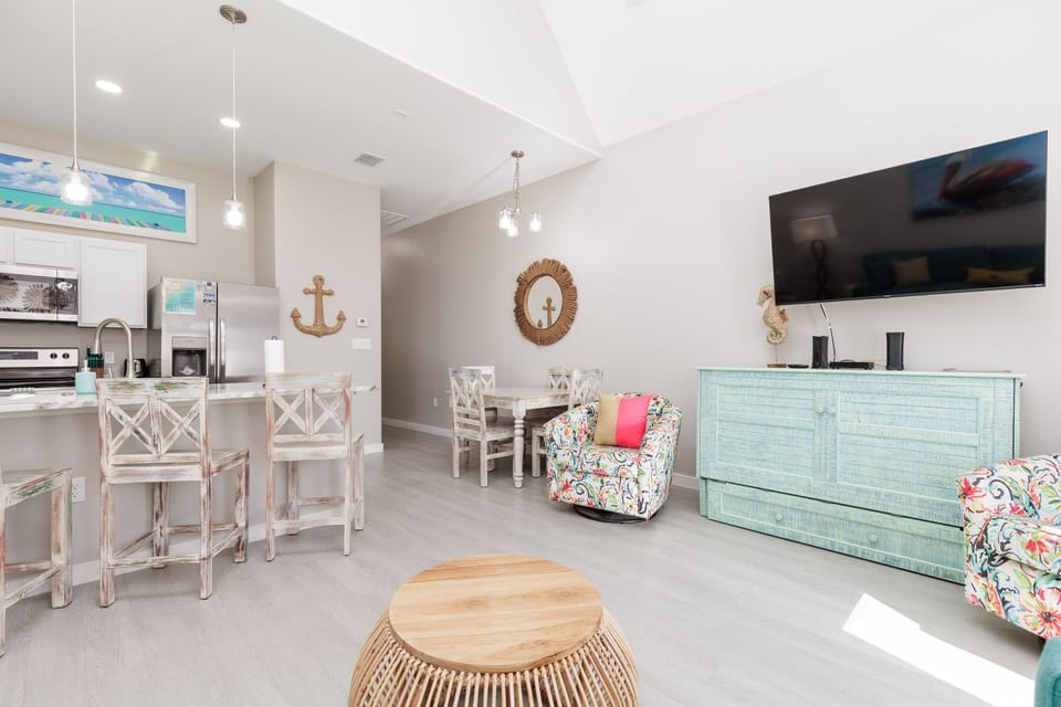 Your bright coastal retreat features an open-plan design where kitchen flows into living space, creating perfect spots for cooking together and relaxing.
