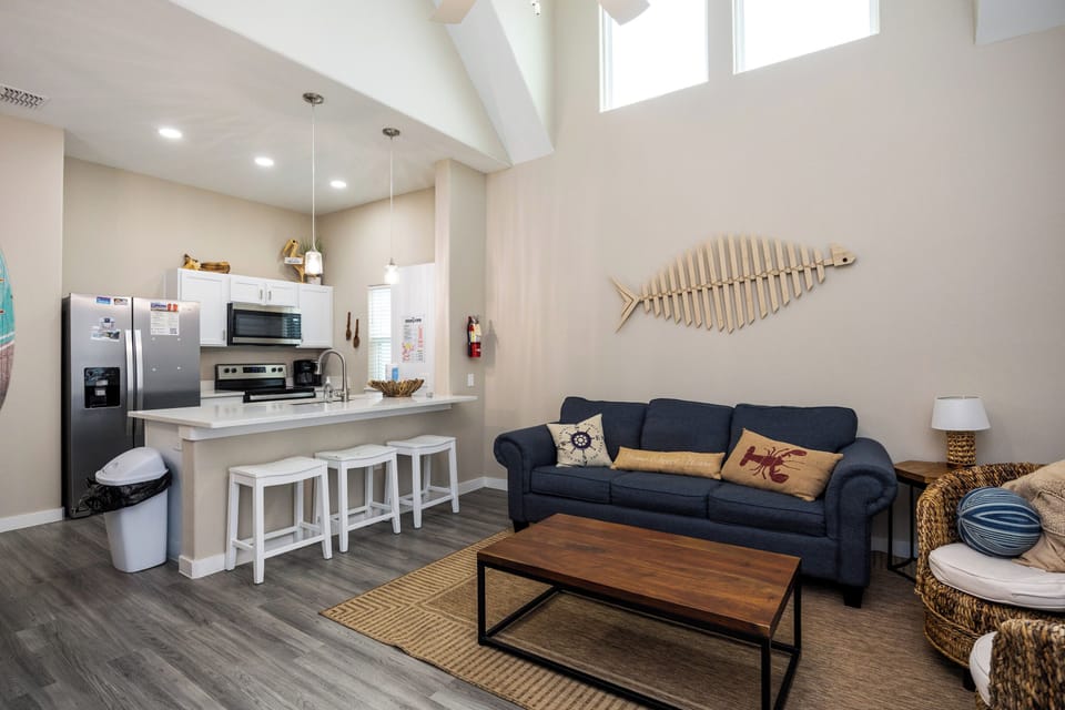 Unwind in your bright, open living space where coastal charm meets modern comfort—complete with full kitchen and nautical touches.