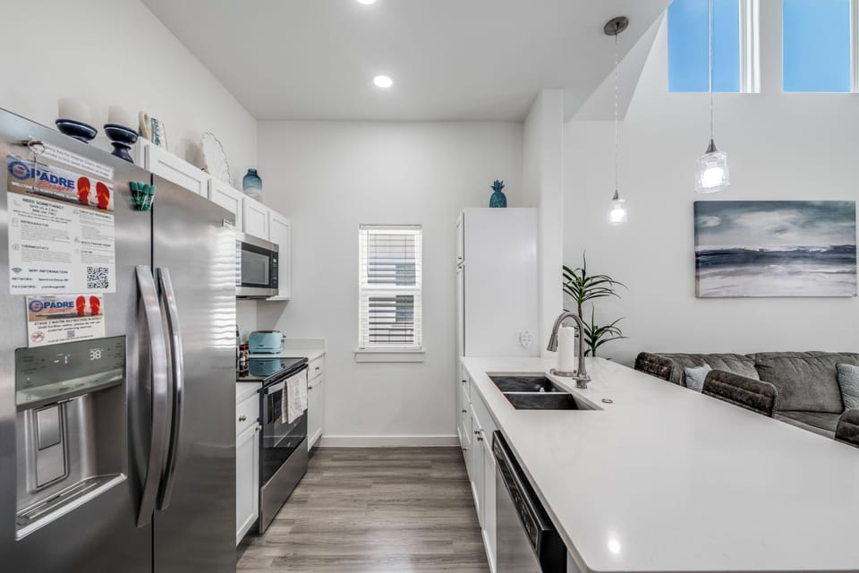 Your modern galley kitchen features stainless steel appliances and sleek white counters, perfect for preparing meals during your stay.