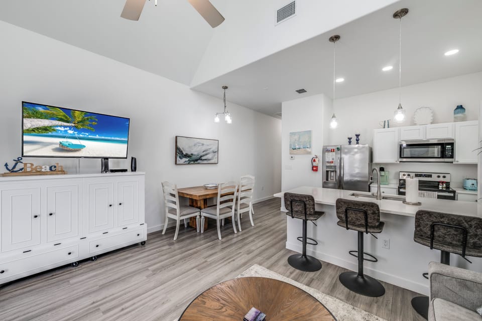 Your open-concept living space flows seamlessly from kitchen to dining, with stainless steel appliances and cozy seating perfect for memorable meals together.